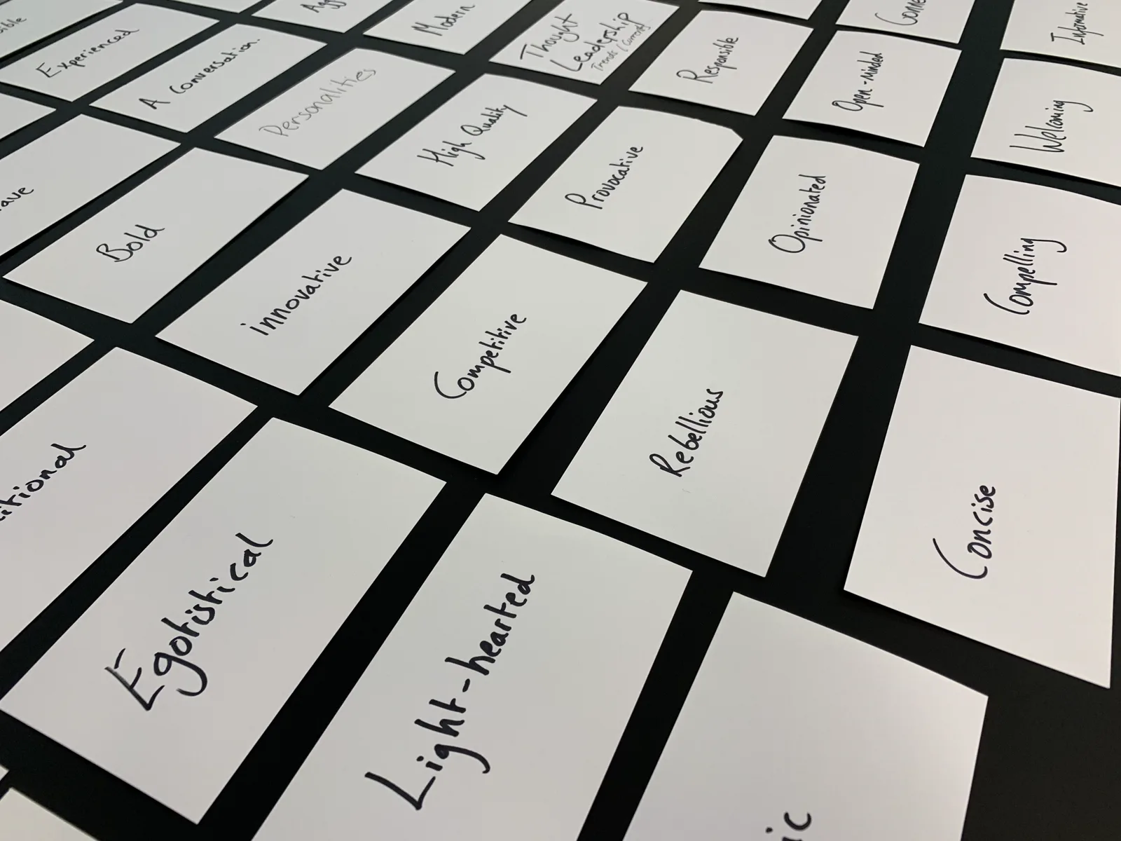 White cards printed with single words arranged on a dark surface